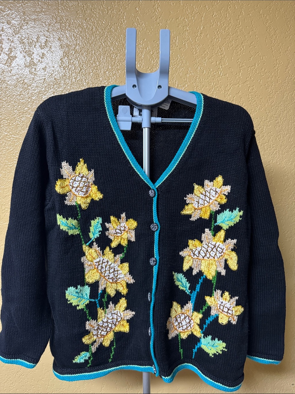 Storybook Knits Black Cardigan with Yellow Floral Embroidery and Turquoise Trim